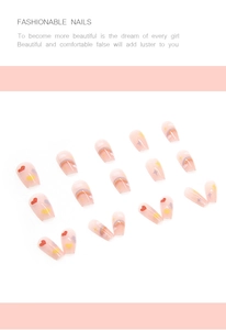 Detail of coffin-shaped press-on nails with nude pink base, rainbow and heart art