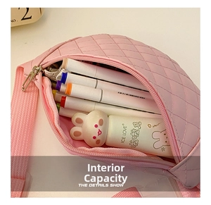 Detail shot of pink PU leather chest bag interior showing spacious capacity for pens