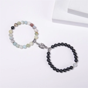 Close-up of beaded couples bracelets with magnetic hand-holding clasp and natural stones