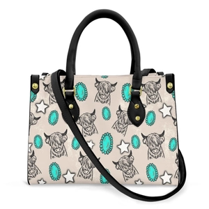 Detail of highland cow print and golden studs on cream leather crossbody tote bag