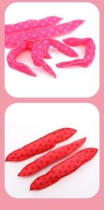 Detail view of pink and red polka dot heatless hair rollers made of soft fabric material