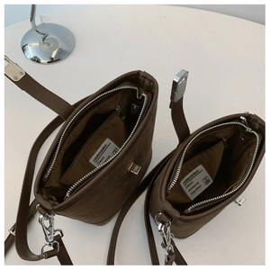 Internal view of brown vintage bucket bag showing large capacity and zipper compartments