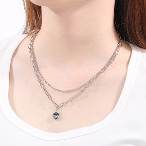 Double-layered stainless steel necklace featuring a heart pendant and bead chain design