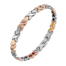 Detail of a bicolored magnetic therapy bracelet with rose gold and silver X-shaped links