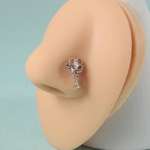 Detail of winged heart nose stud with red and teardrop stones on silicone model