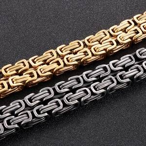 Macro shot of gold and silver Byzantine link chains with double layer stainless steel detail