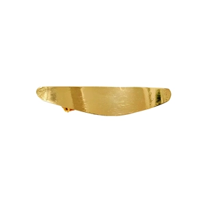Close-up of golden metal bow hair clip showing elegant brushed texture finish