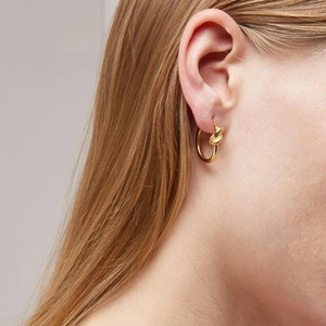 Elegant gold knot hoop earrings for women with a minimalist twisted metallic design