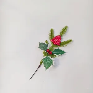 Christmas pine branch with red berries and snowy wooden tree pendant on white background