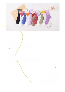 Flat lay of colorful mid-calf socks with creative melting paint drip patterns on the cuffs