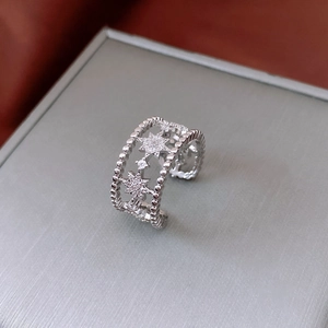 Detail of silver hollowed double-layer ring featuring starburst white zircon stones