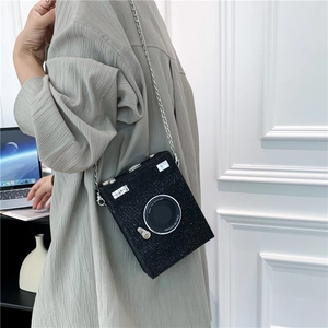 Retro camera-shaped crossbody bag in black glitter finish with silver chain strap