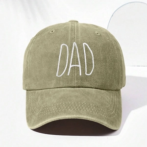 Detail of white DAD embroidery on a washed olive green cotton canvas baseball cap