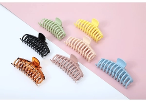 Detailed view of large matte hair claws in a variety of vibrant colors arranged neatly