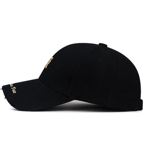 Distressed black cotton baseball cap with gold embroidery on white background