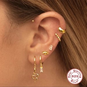 S925 Sterling Silver rectangular diamond earrings shown on model ear in golden finish