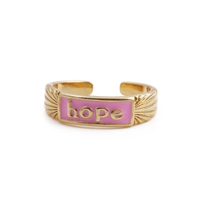 Close-up of pink enamel 'hope' lettering on a golden adjustable copper ring band