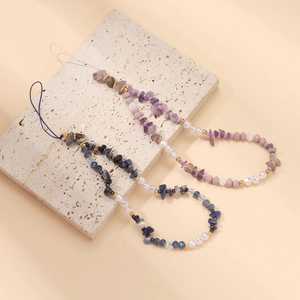 Detail of handmade beaded phone straps with colorful gemstones and acrylic pearls