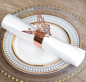 Detailed view of rose gold butterfly napkin ring with hollow laser-cut metal design
