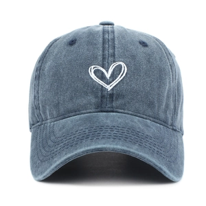 Vintage washed navy cotton baseball cap with white embroidered heart on a white background