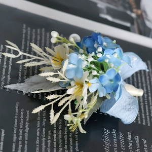 Blue and white artificial wedding boutonniere with elegant silk ribbons and greenery