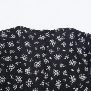 Detailed close-up of floral print fabric with hidden back zipper closure on dress