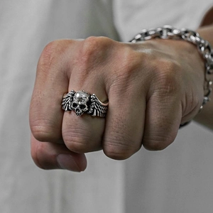 Retro punk skull ring with wings in vintage silver finish for men on a hand