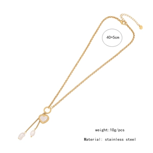Detail view of gold heart necklace with white pearl and stainless steel chain length 40+5cm