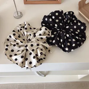 Polka dot satin scrunchies in cream and black colors with elegant pearl decoration