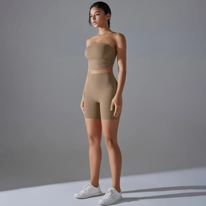 Detail of dark khaki tube top and biker shorts yoga set on model with side lighting