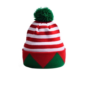 Macro detail of red and white striped knit Christmas hat with green pompom and triangle pattern