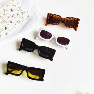 Set of four vintage rectangle sunglasses in leopard print, white, and black colors