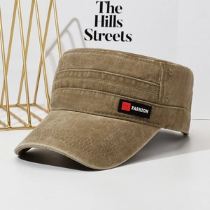 Washed khaki flat top military cap with a black Fashion label in a modern setting
