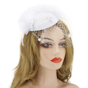 Detail of bridal fascinator hat with white floral lace, pearls and delicate mesh veil