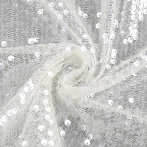 Detailed macro shot of white sequin lace fabric with delicate mesh texture for dresses