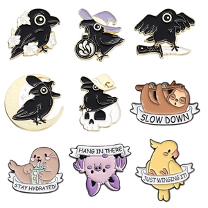 Cartoon enamel pin set featuring black crow, seal, sloth, and bat with motivational quotes