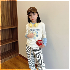Close-up of children's cream long-sleeved T-shirt with blue拼接袖 and dog print