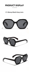 Macro detail of large polygon sunglasses showing glossy black frames and tortoiseshell temples