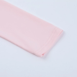 Close-up of pink long sleeve dress cuff showing fine double stitching and knit texture