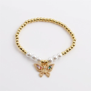 Elegant gold beads and white pearls bracelet with a colorful zircon butterfly pendant