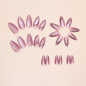 Detail of almond cat-eye press-on nails with purple bow design and silver glitter accents