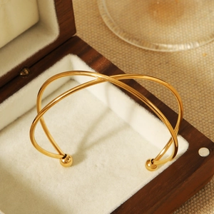 Minimalist 18k gold plated stainless steel crisscross cuff bracelet with ball ends