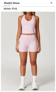 Front view of peach pink yoga set featuring a V-neck tank top and drawstring shorts