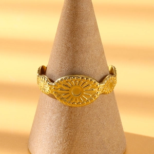 Macro shot of gold sun pattern relief on bohemian stainless steel open bangle