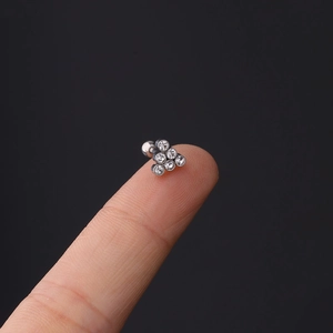 Macro shot of 16g stainless steel cartilage stud with six round cubic zirconia stones