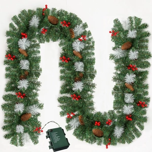 Detail of 9ft green Christmas garland with pine cones, red berries, and battery control box