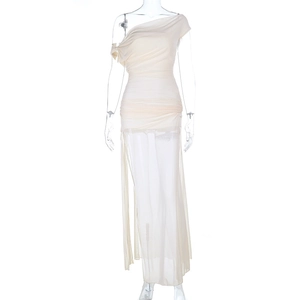 Detailed view of cream asymmetrical dress with ruched fabric and sheer split hem