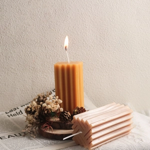 Primer plano de velas de pilar acanaladas con mecha de algodón en ambiente decorativo