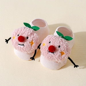 Close-up of pink baby floor socks with cartoon plush toys and soft knit texture