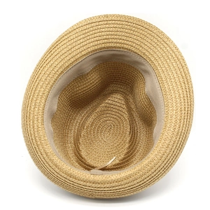 Macro shot showing the inner spiral weave and beige sweatband of the straw sun hat